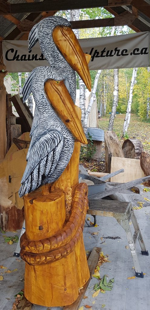 Chainsaw carved pelicans