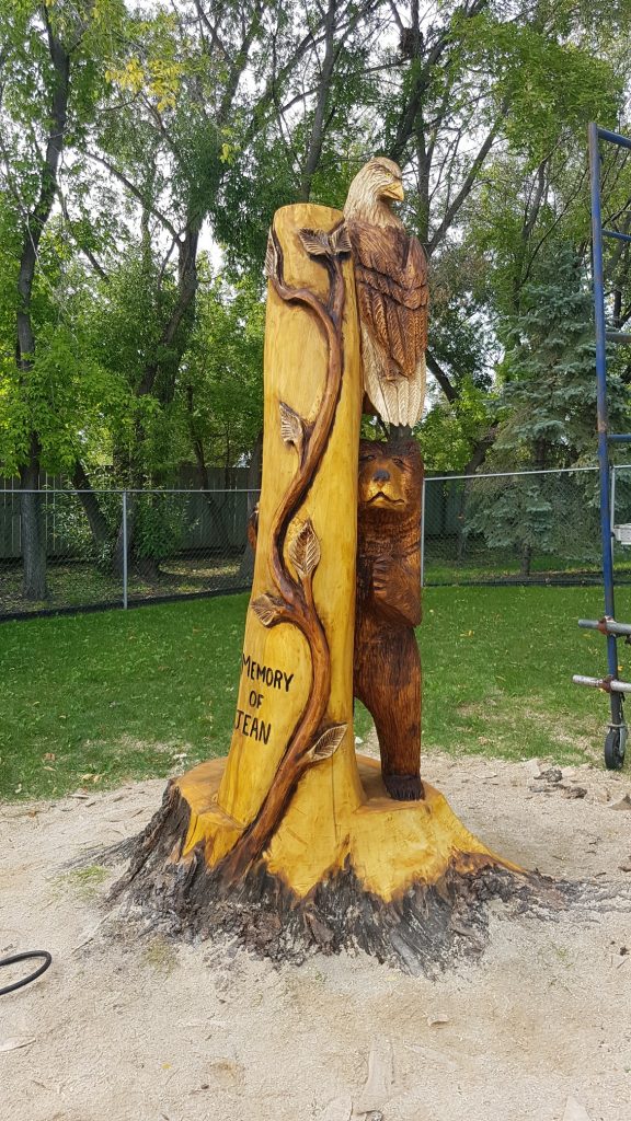 Bear and eagle memorial stump carving 