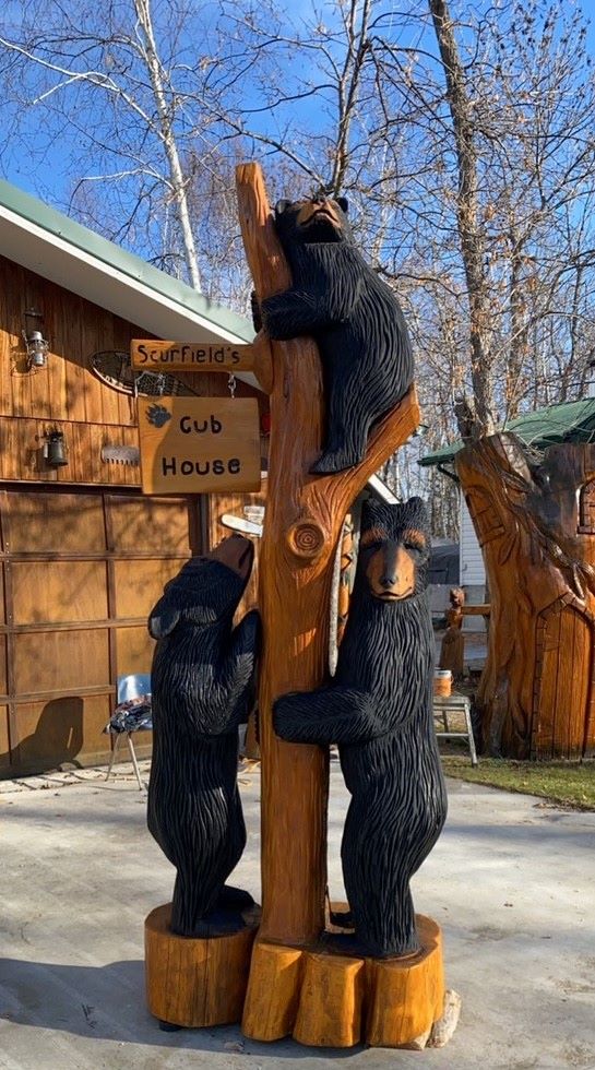Three bears in tree chainsaw carved out of red cedar 