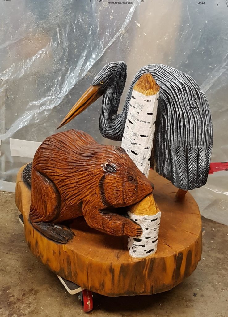 chainsaw carved beaver and heron