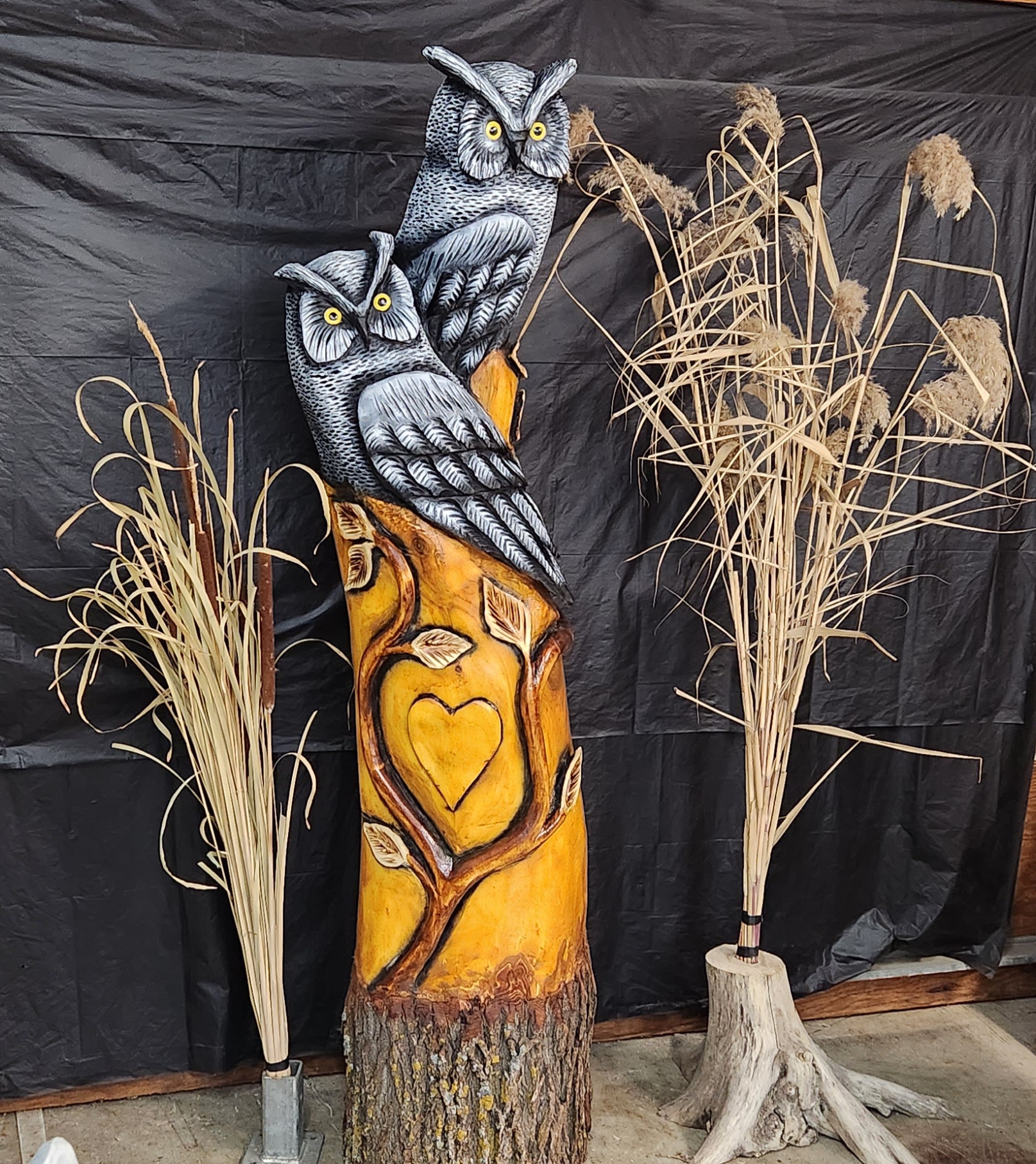 chainsaw carved owls and vine carved out of golden willow