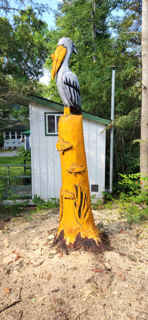 chainsaw carved pelican and fish