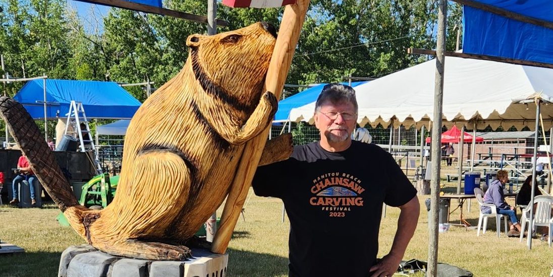 Chainsaw carved beaver with Canada flag